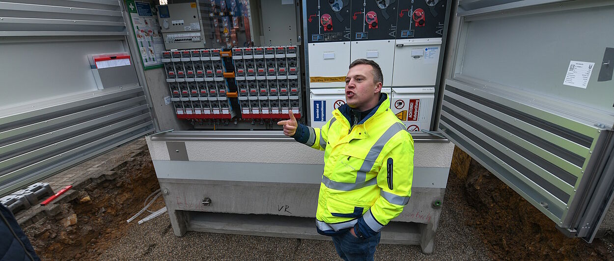 Mann vor Ortsnetztrafostation